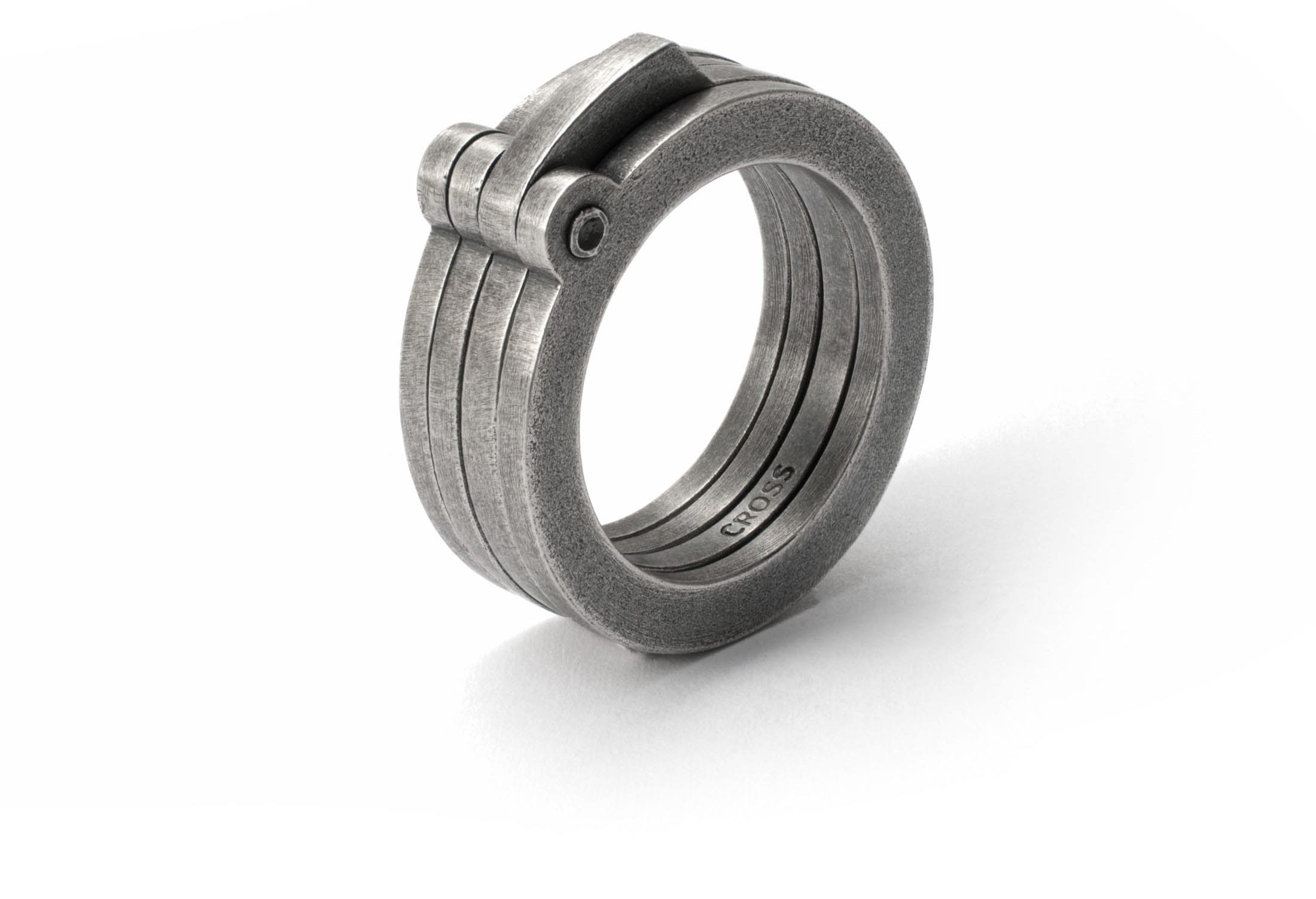 Stacked and riveted silver rings set with patina by CROSS ELEMENTS