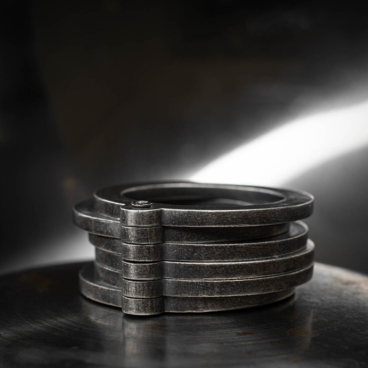 Stacked silver rings on surface